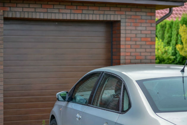 A car parked in front of a garage