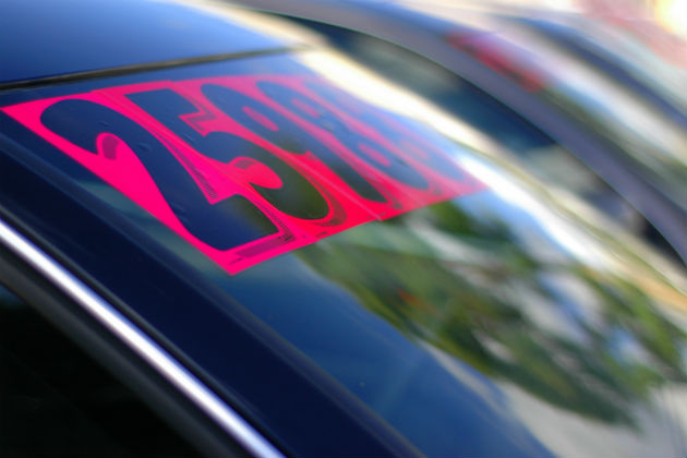 A price sticker on the windscreen of a car