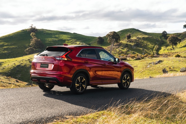 Red Mitsubishi Eclipse driving in countryside