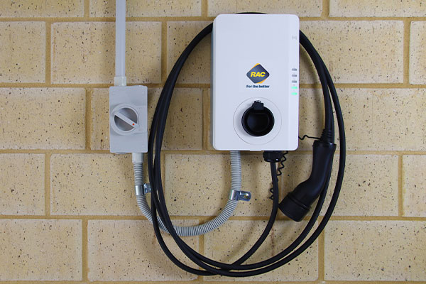 The RAC EV home charger mounted on a garage wall