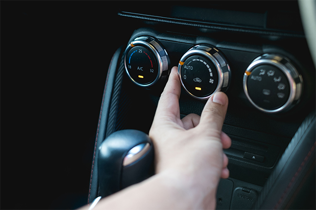 Image of person adjusting air con