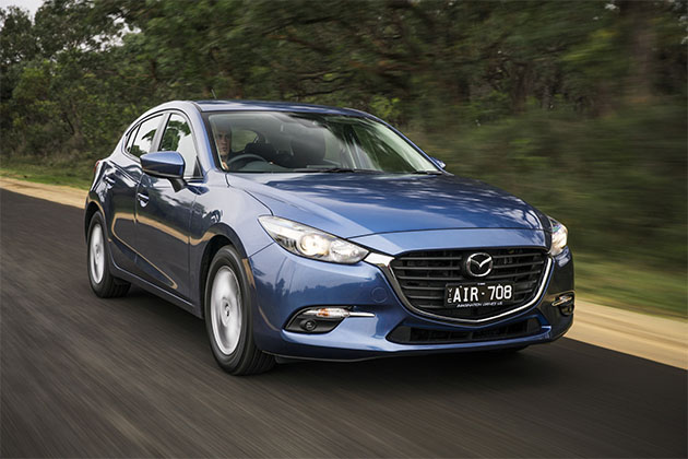 Blue Mazda3 Maxx Sport driving on the road