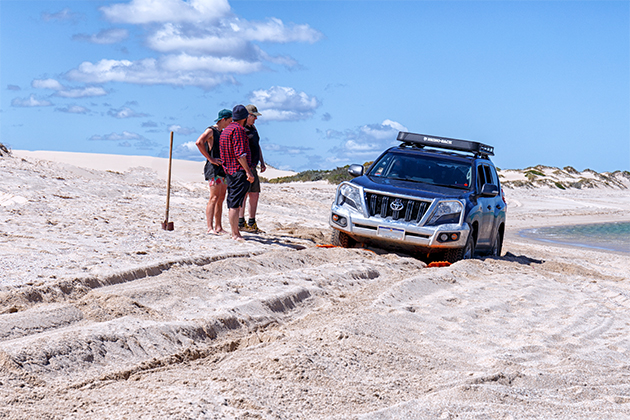 Image of car bogged in sand