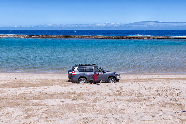 Image of person using a shovel on four-wheel drive