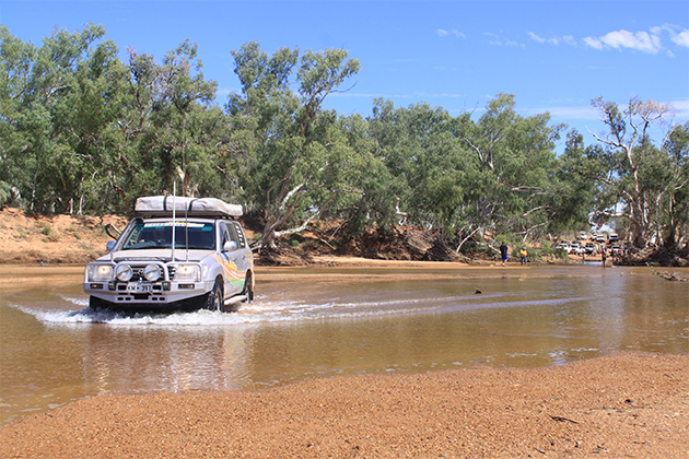 Image of four-wheel drive crossing water