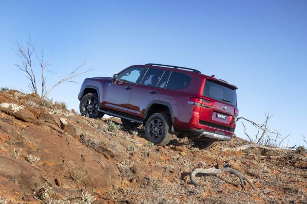 Red Toyota Landcruiser 300 Series driving off road