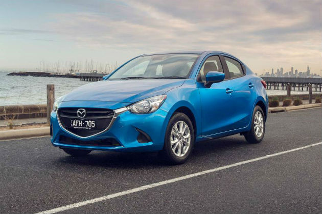 Blue 2015 Mazda2 on the road