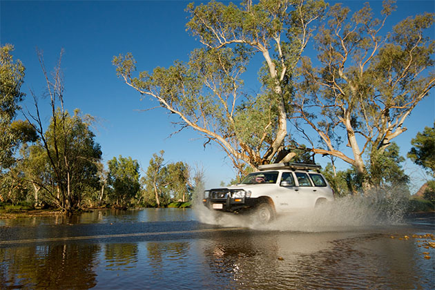 A four wheel drive crossing a body of water