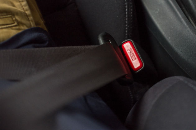 A close up of a seat belt clicked into place