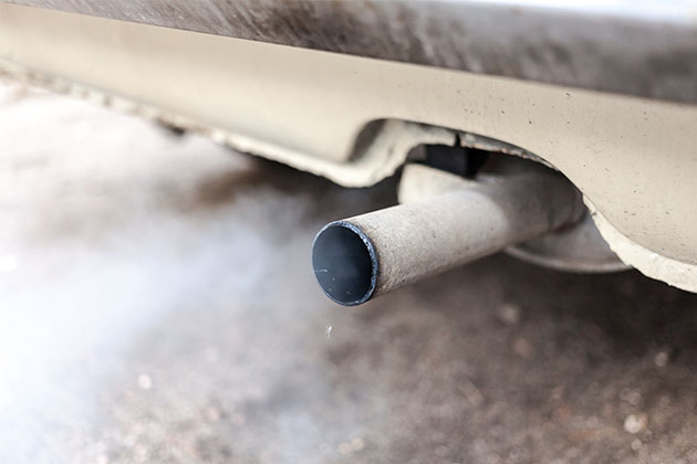 Smoke coming from a car exhaust pipe