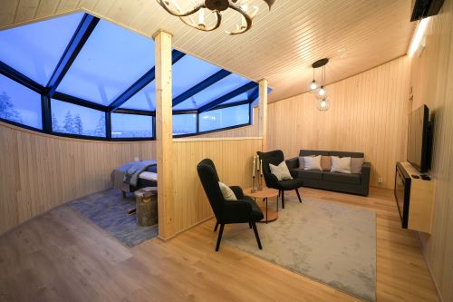 Modern interior of the Livo Arctic Resort with a big panoramic ceiling window over the bed to watch the Northern Lights
