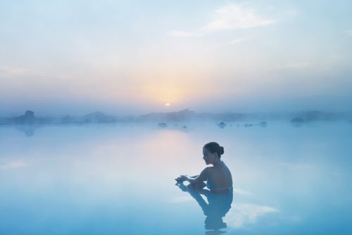 A woman sitting in the Blue Lagoon geothermal waters 