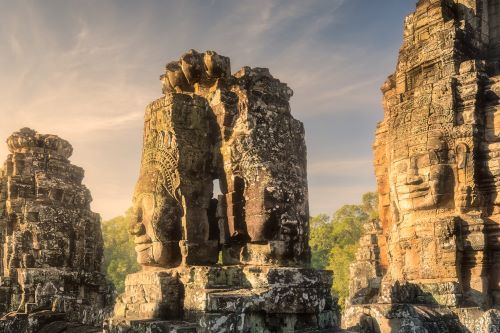 The stone faces of the Bayon Temple in Cambodia illuminated by the sun