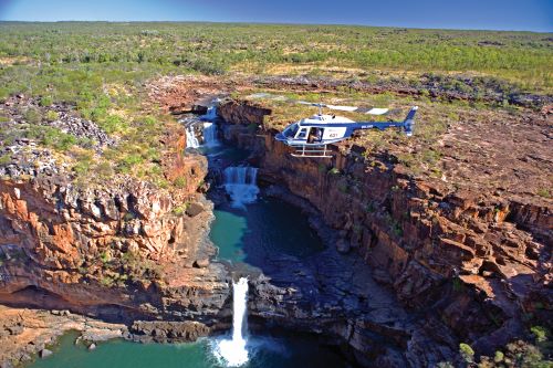 A helicopter flying over Mitchell Falls in the Kimberley region