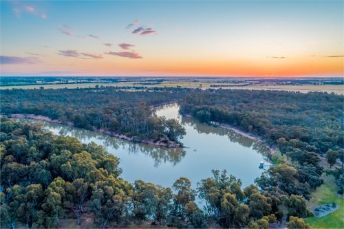 Aerial view of the Murray River and surrounding bush at sunset 