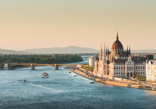 Magnificent Budapest Parliament House at the riverbed by sunset