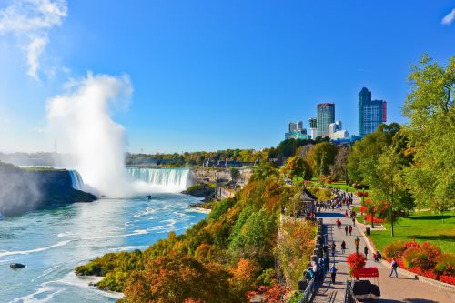 Niagra Falls with autumn trees and buildings surrounding 