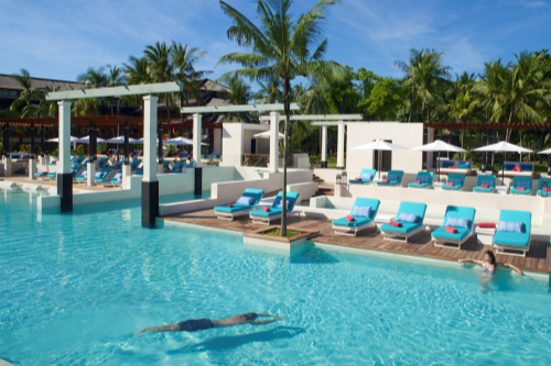 A serene pool area with a couple enjoying a dip