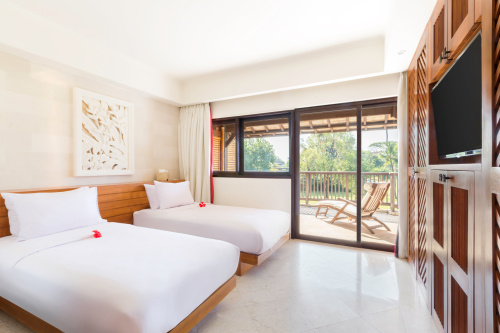 A modern room with balcony kept in cream and wooden colours.