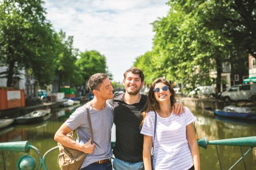 Young travellers enjoying sunshine in Amsterdam. 