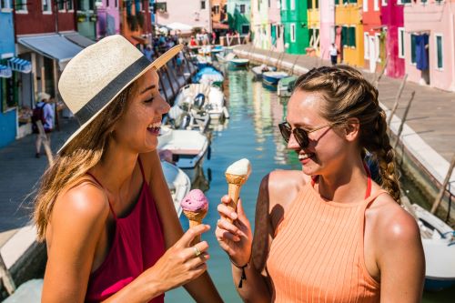 Two young travellers enjoying some ice-cream in the sun 