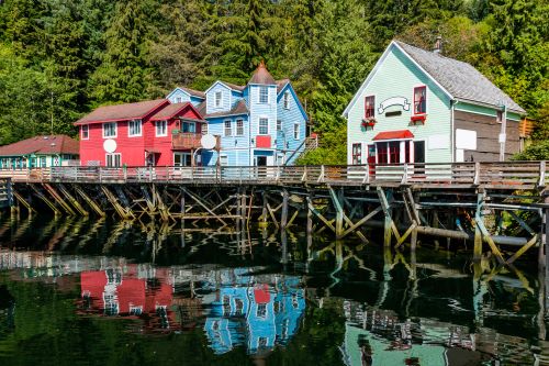 Ketchikan’s colourful wooden houses built on stilts along the water’s edge nestled against lush green hills