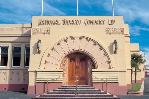 The front of a building in art deco style with the inscription National Tobacco Company LTD