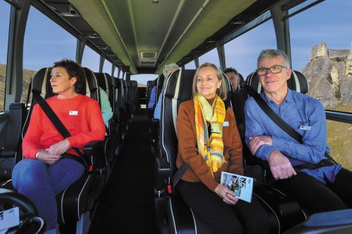 Some travellers sitting in the comfortable seats of the GPT coach which has big windows to enjoy the views