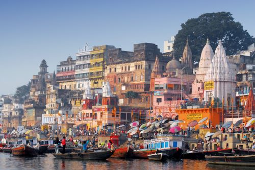 Boats on the Ganges River beside the vibrant ghats of Varanasi.