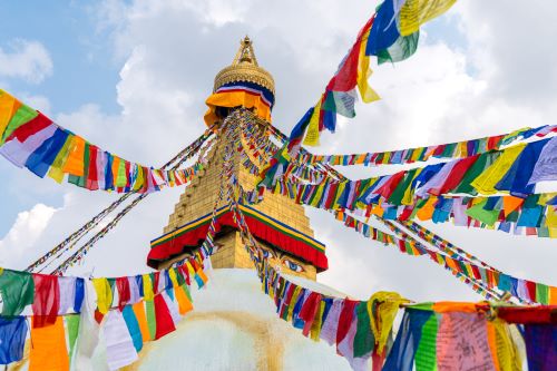 Boudhanath Stupa adorned with colourful prayer flags in Kathmandu.