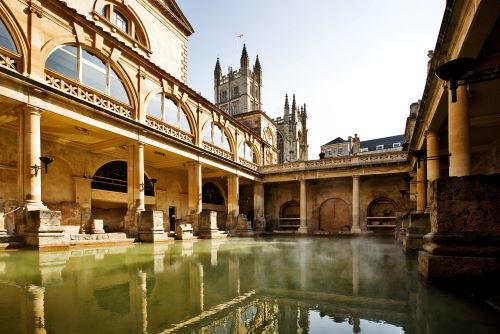 A well-preserved Roman thermae complex with light steam evaporating above the water