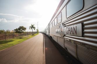 The Ghan parked at Darwin terminal focus on the Ghan logo displayed on one of the carriages.