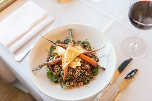 A beautifully arranged meal on a  table set with white table cloth