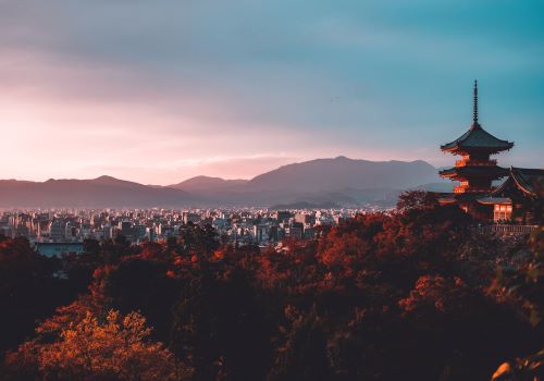 Kiyomizudera temple in front of Kyoto's skyline by sunset 