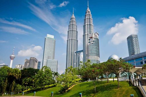 Low angle shot of the Kuala Lumpur skyline with the Petronas Twin Towers in the centre
