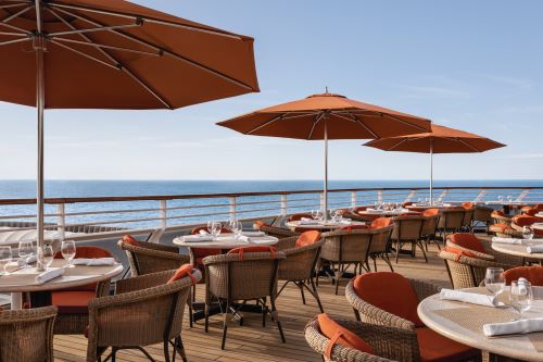 Outdoor Terrace Cafe with lots of parasols aboard the Oceania vessel