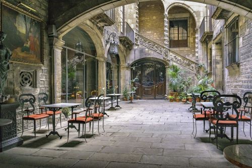 A small terrace with table and chairs in an old town of Barcelona