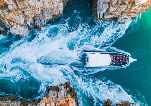 A top down drone shot of a fast boat going through the Horizontal Falls