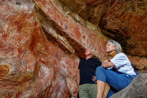 A couple looking at aboriginal rock art 