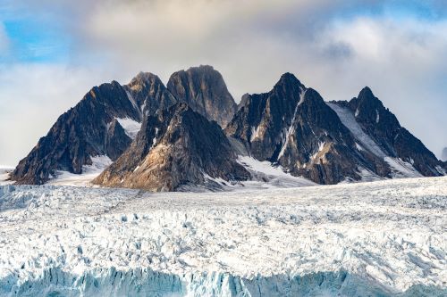 Tall mountains surrounded by snow and ice