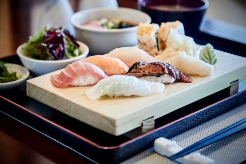 A closeup photo of nicely arranged sushi served on a board