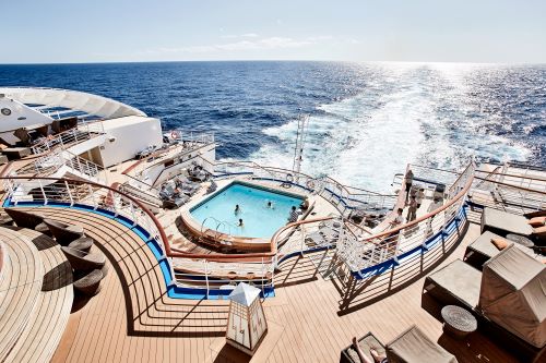 Passengers enjoying the pool at the back of the ship