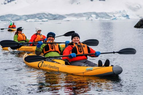 Some guests sitting in a kayak on a paddling excursion through the polar waters