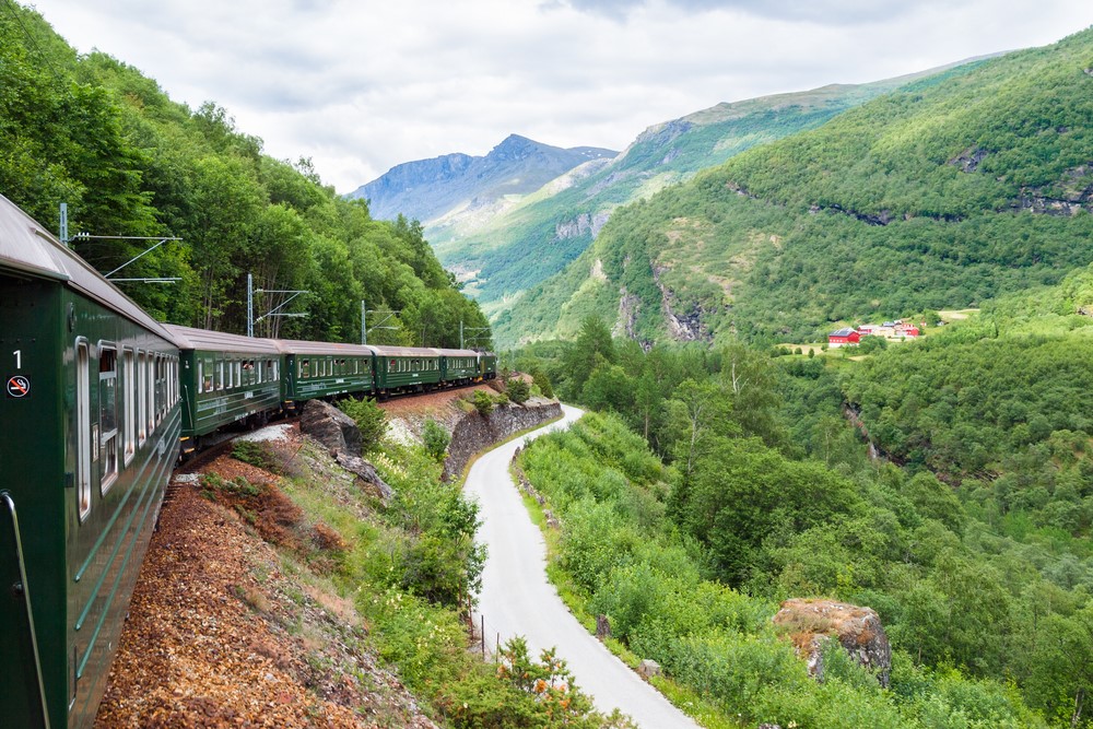 The Flamsbana Train driving through picturesque mountain landscape in Norway