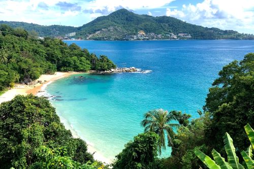 A picturesque bay with turquoise water and green mountain scenery in the background