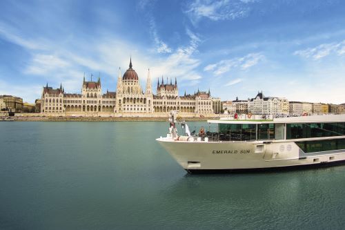 The Emerald Sun cruising down the river with Budapest's skyline in the background 