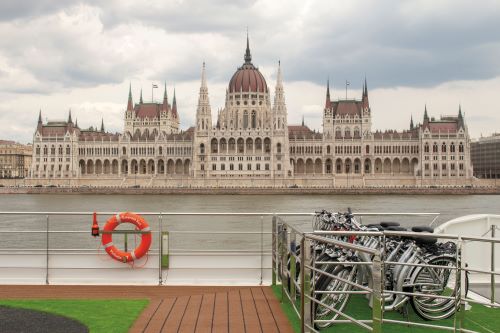 Bikes parked on the sun deck aboard the Emerald river vessel with Budapest skyline in the background 