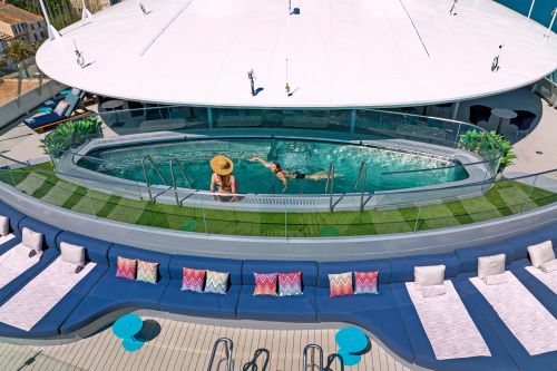 Aerial shot of the pool on the sky deck with people enjoying the water 