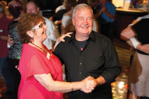 A mature couple dancing together and having fun