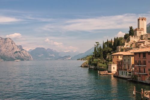 A quaint town overlooking Lake Garda with the Dolomites in the background 